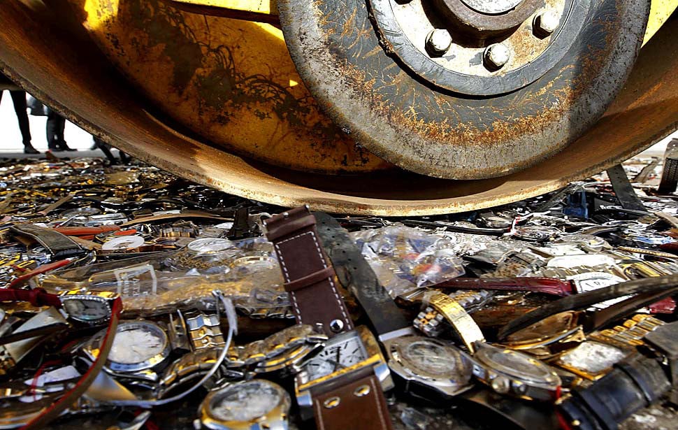 fake watches being crushed